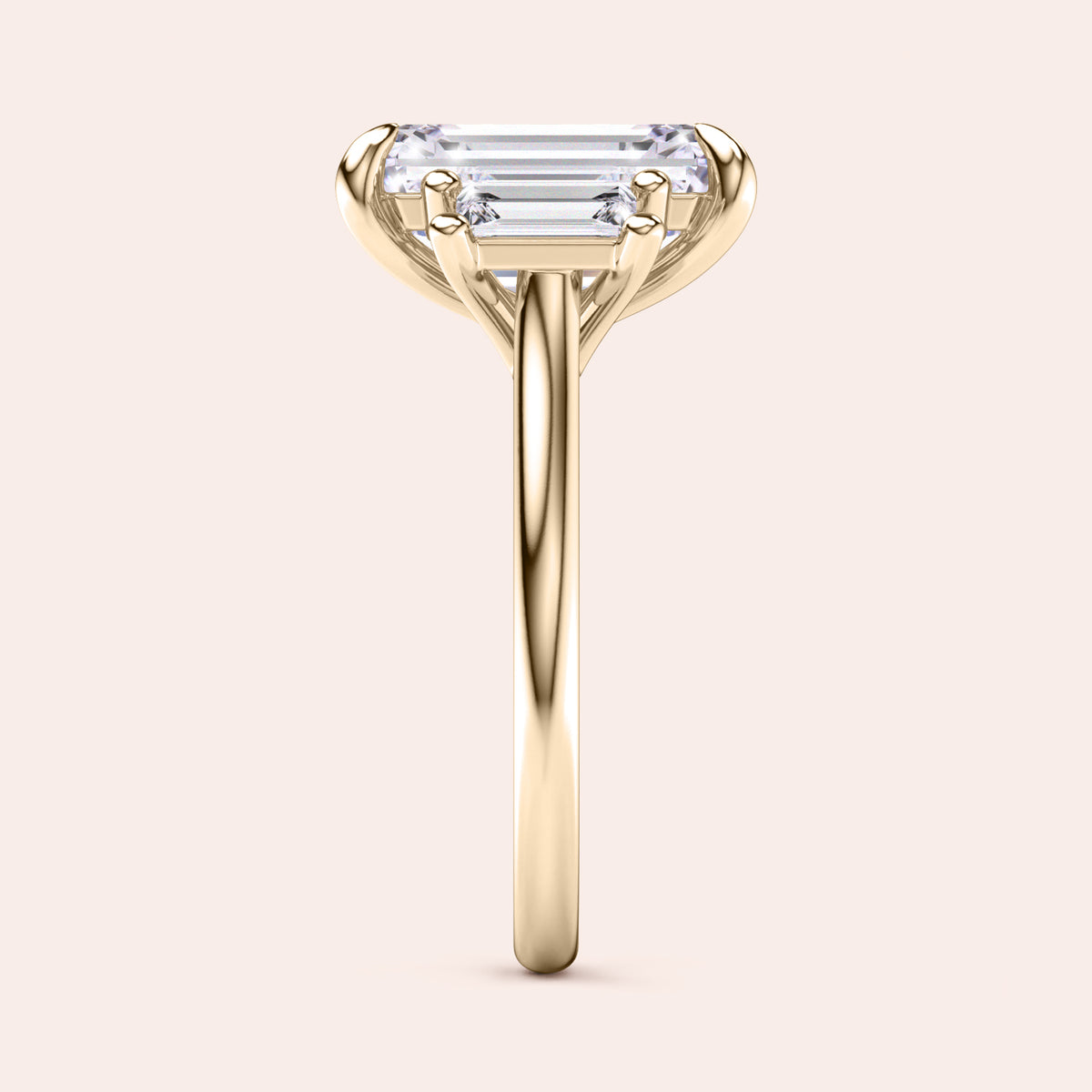 Radiant-cut diamond engagement ring with side stone accents in 14K yellow gold, displayed on a neutral background.