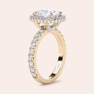 Radiant-cut diamond engagement ring with side stone accents in 14K yellow gold, displayed on a neutral background.