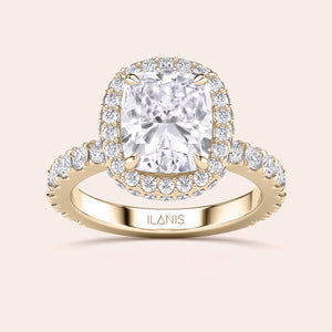 Radiant-cut diamond engagement ring with side stone accents in 14K yellow gold, displayed on a neutral background.