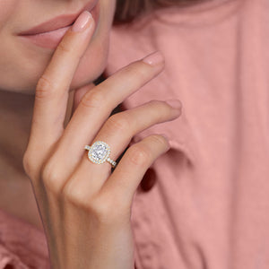 Radiant-cut diamond engagement ring with side stone accents in 14K yellow gold, displayed on a neutral background.