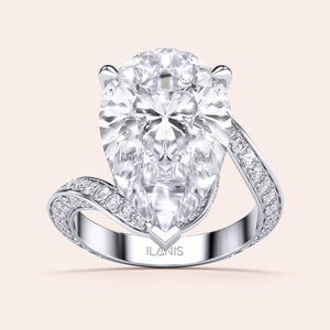 Elegant pear-shaped diamond engagement ring in 14K/18K gold or platinum, featuring a sparkling diamond-studded band.