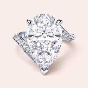 Elegant pear-shaped diamond engagement ring in 14K/18K gold or platinum, featuring a sparkling diamond-studded band.