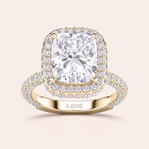 Radiant-cut diamond engagement ring with side stone accents in 14K yellow gold, displayed on a neutral background.