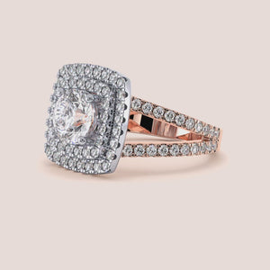 Two-tone 14K rose and white gold diamond ring featuring a cushion cut, showcased elegantly on a model's hand. 