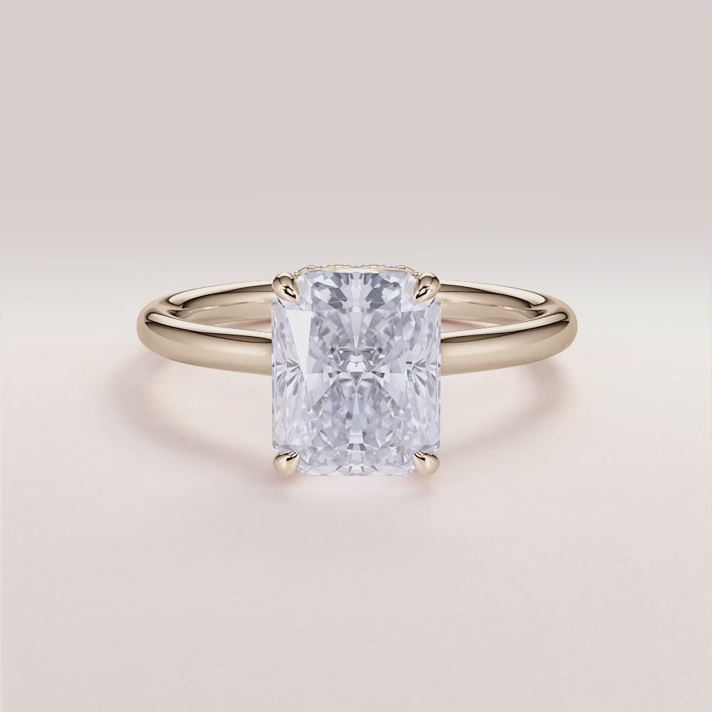 Radiant cut diamond engagement ring with hidden halo and plain band in 14K or 18K gold or platinum, worn on model.|

#14KRecycledYellowGold
#18KRecycledYellowGold
