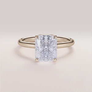 Radiant cut diamond engagement ring with hidden halo and plain band in 14K or 18K gold or platinum, worn on model.
