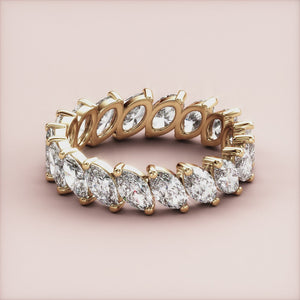 Golden marquise diamond eternity wedding band in 14K or 18K gold or platinum, showcasing timeless elegance and craftsmanship. 