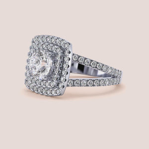 Stunning engagement ring with round diamond center in 14K or 18K gold, featuring a double halo and pave detailing for added elegance.
