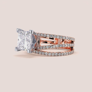 Two-tone 14K rose and white gold engagement ring featuring a princess-cut diamond and swirl pave band design. 