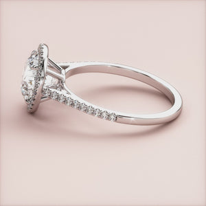 Elegant 14K white gold engagement ring featuring a round halo and pave band, adorned with sparkling diamond accents.