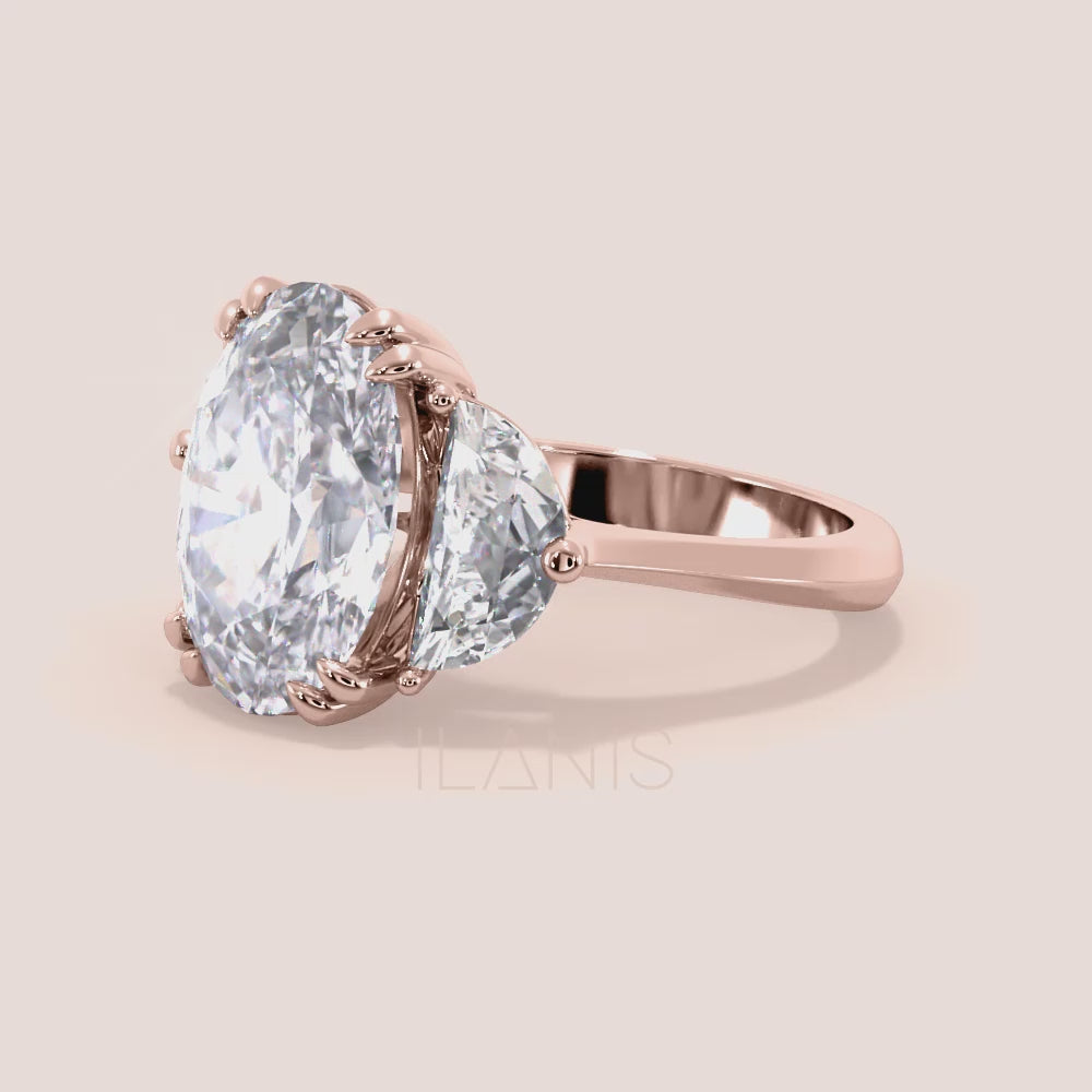 Close-up video of oval diamond three stone engagement ring in rose gold with pear side diamonds, showcasing sparkle, prong setting details and fine craftsmanship in motion | #14KRecycledRoseGold #18KRecycledRoseGold