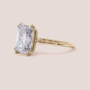 Luxurious engagement ring featuring an emerald-cut diamond in a sleek 14K, 18K, or platinum band, perfect for upscale collections. 