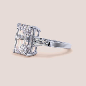 "Elegant 14K white gold engagement ring featuring emerald and three tapered baguette diamonds for a stunning proposal.