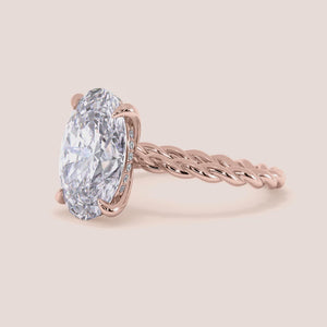 "Rose gold 14K engagement ring featuring a twisted band design for a unique and elegant style. Perfect for romantic proposals.