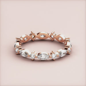 Elegant marquise diamond eternity band in 14K rose gold, featuring alternating marquise and round diamonds. 