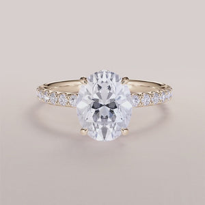 14K yellow gold engagement ring featuring an oval wrapped hidden halo, prong accents, and pave-set diamond band, side view.

#14KRecycledYellowGold
#18KRecycledYellowGold