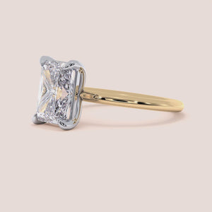 Two-tone 14K/18K white and yellow gold engagement ring featuring a radiant-cut diamond, elegant and timeless design. 