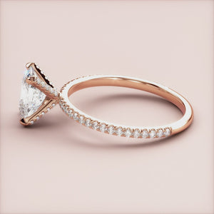 Close-up of an elegant rose gold engagement ring with a marquise diamond andPave band, available in 14K, 18K, or platinum.