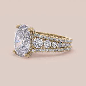 Elegant 14K yellow gold engagement ring featuring an oval hidden halo with prongs and a three-row band for a stunning look.