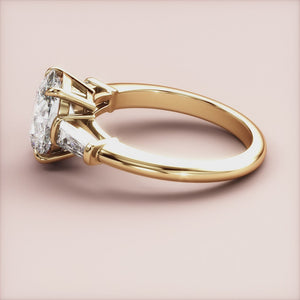 Elegant 14K yellow gold engagement ring featuring an oval-cut diamond and tapered baguette diamonds, not worn on a model.