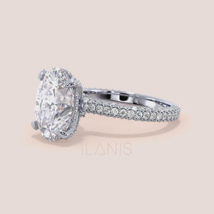 Oval cut diamond ring in white gold with pavé band and hidden halo, close-up video highlighting fire, brilliance and fine diamond details 