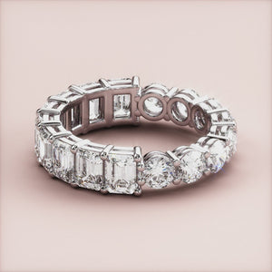 14K or 18K white gold eternity wedding band with emerald-cut diamonds, perfect for special occasions, shown on model's hand. 
