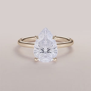 Elegant 14K yellow gold pear classic solitaire engagement ring featuring a stunning diamond, perfect for a timeless proposal.