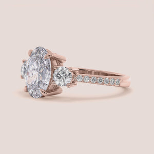 "Rose Gold 14K Reese Oval Three Stone Engagement Ring with Pave Side Stones - Elegant and Timeless Jewelry for Every Occasion.