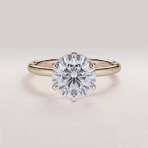 Elegant round diamond engagement ring in 14K yellow gold, featuring a hidden halo design and a sleek plain band.