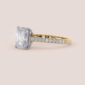 Two-tone 14K/18K gold engagement ring featuring a radiant-cut diamond in a cathedral setting with a pave diamond band. 