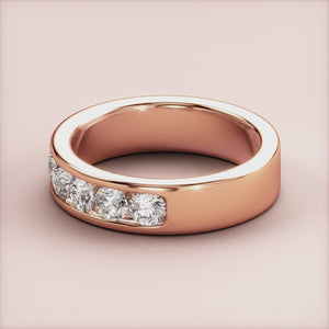 Elegant 14K or 18K rose gold diamond eternity band featuring round brilliant-cut diamonds in a classic channel setting. 