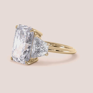 "Elegant 14K yellow gold engagement ring featuring emerald and three tapered baguette stones for a stunning vintage-inspired look.