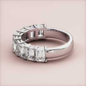Elegant emerald-cut diamond wedding band in 14K or 18K white gold setting, featuring a row of sparkling emerald diamonds. 