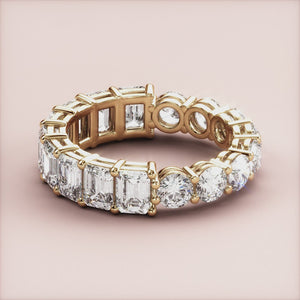 Elegant yellow gold wedding band, 14K or 18K, featuring emerald-cut diamondsâ€”timeless eternity design for luxurious style. 