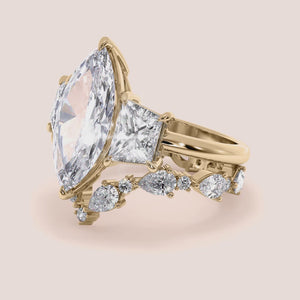 Radiant cut diamond engagement ring in 14K yellow gold with split-shank design and round diamond accents for a stunning look.