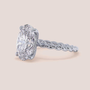 """Elegant 14K white gold twisted band engagement ring, featuring a unique oval design, perfect for modern weddings.""