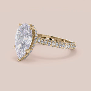 "14K yellow gold Emery pear engagement ring with hidden halo accents and 3D pave prongs, perfect for timeless elegance.