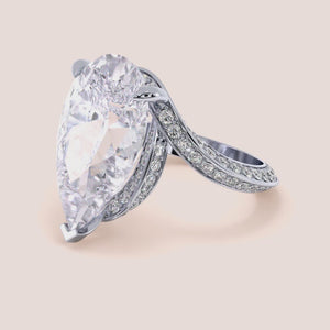 14K white gold pear-shaped engagement ring with hidden halo accents and 3D pave design, perfect for romantic proposals. 