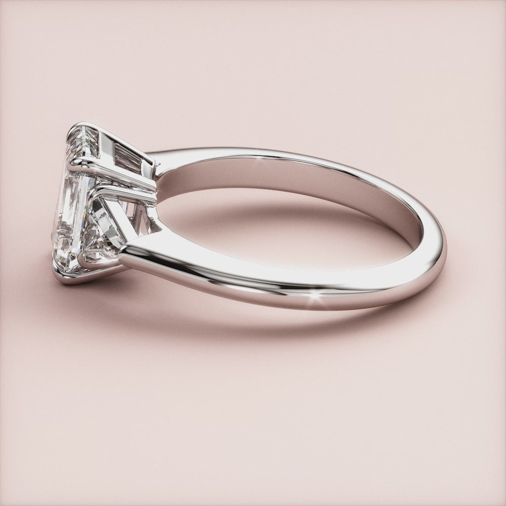 """14K white gold three-stone engagement ring with emerald accents, perfect for a unique and elegant proposal.""|

#14KRecycledWhiteGold
#18KRecycledWhiteGold








#Platinum"
