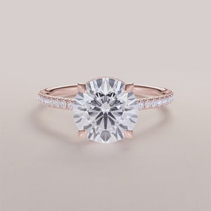 Elegant halo engagement ring featuring an oval-cut diamond, set in a 14K or 18K rose gold band with accent diamonds.