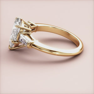 Elegant 14K yellow gold butterfly engagement ring with a pear-shaped diamond and tapered baguettes, showcasing exceptional craftsmanship.