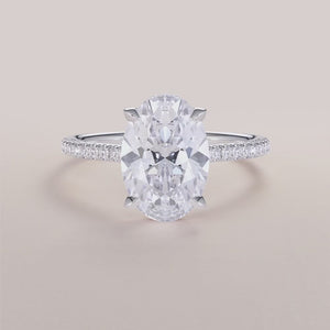"Elegant 14K white gold oval engagement ring with hidden halo and pave band design, perfect for timeless romance.