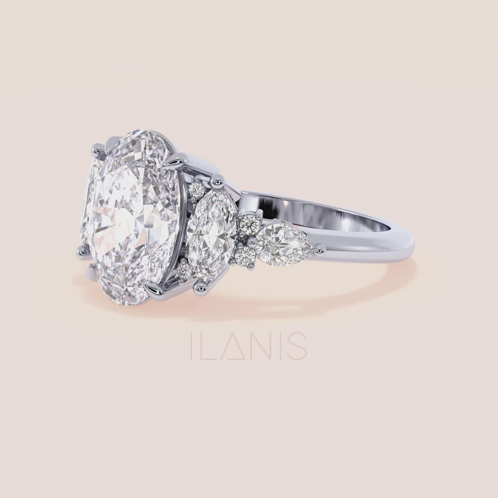 White gold oval three stone diamond engagement ring vertical side view with pear side stones, structured gallery and elegant craftsmanship | #14KRecycledWhiteGold #18KRecycledWhiteGold #Platinum