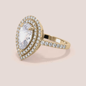 Pear shaped diamond engagement ring yellow gold with double halo and pavé band, side profile view, elevated hidden setting, luxury bridal ring 