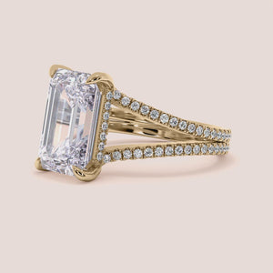 "14K yellow gold emerald split shank hidden halo engagement ring, featuring a stunning invisible gallery design.