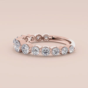 Elegant 14K rose gold wedding band featuring shared prong round-cut diamonds, ideal for special occasions and everyday elegance. 