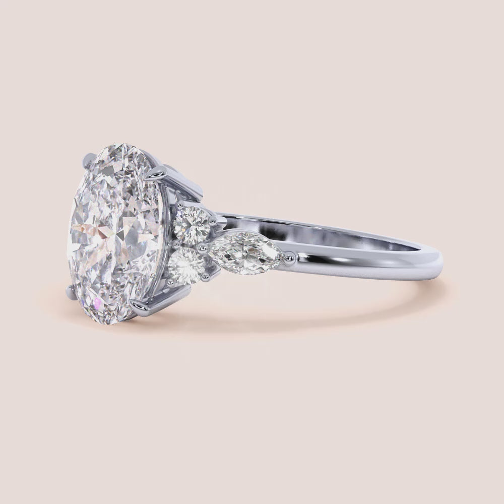 Opal-shaped diamond ring in 14K/18K gold or platinum, with marquise and round accent diamonds, perfect for engagements.
|
#14KRecycledWhiteGold #18KRecycledWhiteGold 
#Platinum



