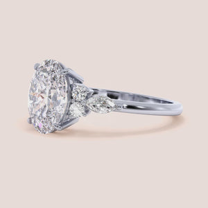 Opal-shaped diamond ring in 14K/18K gold or platinum, with marquise and round accent diamonds, perfect for engagements.
