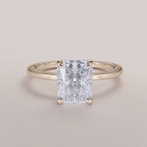 Elegant 14K yellow gold engagement ring with a radiant diamond center stone and delicate halo of smaller diamonds.