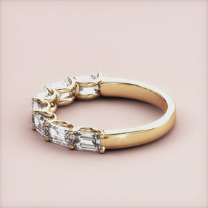 Elegant 14K/18K yellow gold emerald-cut diamond half eternity wedding band, showcasing sophistication and timeless style. 